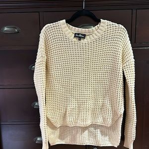 Wool-blend cream colored sweater. Chunky knit in waffle weave pattern.
